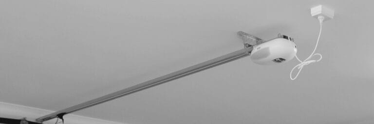 Gliderol Genesis sectional garage door opener unit mounted on a ceiling. - Gliderol